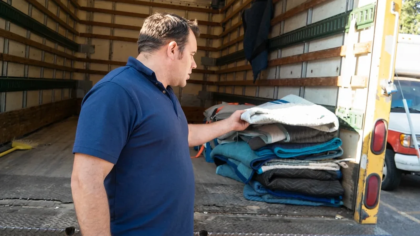 Wrapped furniture carried by movers